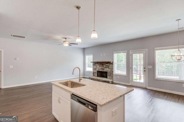 kitchen featuring decorative light fixtures, dishwasher, sink, white cabinets, and ceiling fan with notable chandelier