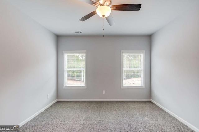 unfurnished room featuring ceiling fan and carpet flooring