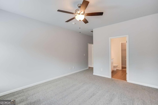 unfurnished bedroom featuring light carpet, ceiling fan, and ensuite bathroom