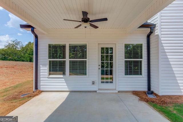 doorway to property featuring ceiling fan and a patio