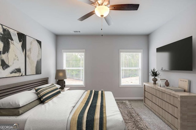 bedroom featuring ceiling fan and light carpet