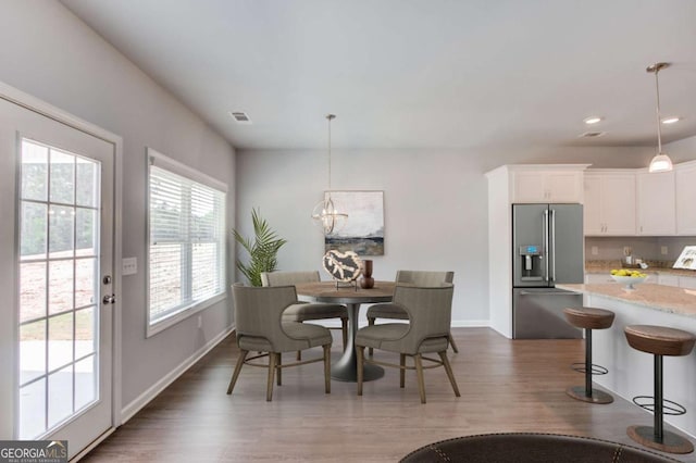 dining room featuring an inviting chandelier and dark hardwood / wood-style flooring