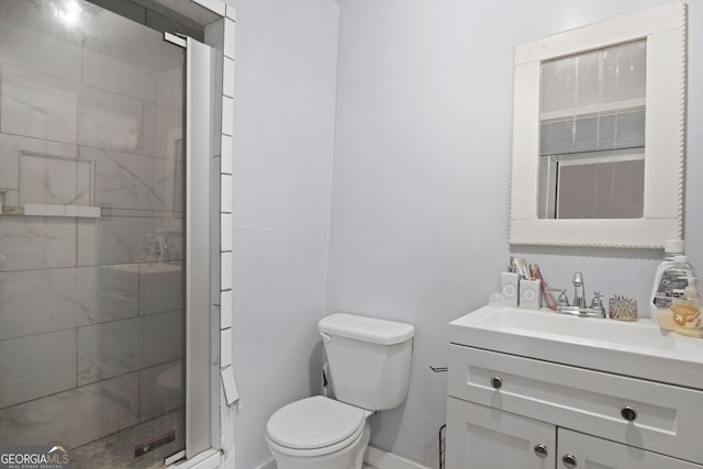 bathroom with a shower with shower door, toilet, and vanity