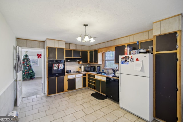 kitchen with an inviting chandelier, decorative light fixtures, a textured ceiling, black appliances, and sink