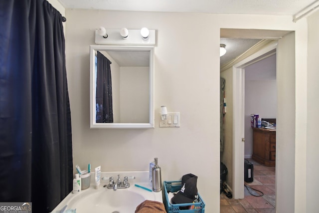 bathroom with a textured ceiling and sink