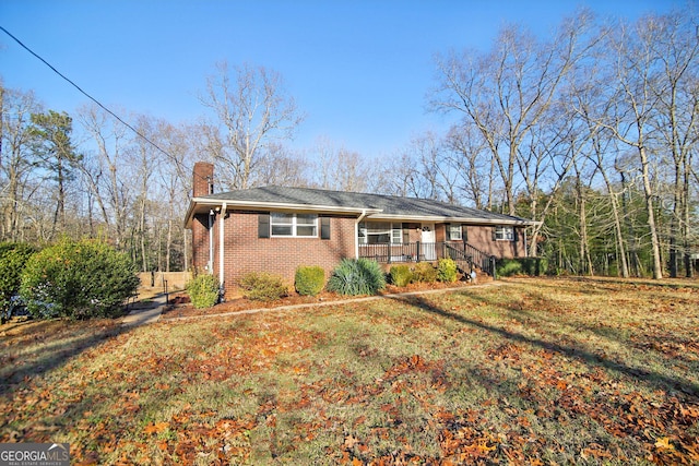 ranch-style house with a front lawn and a porch