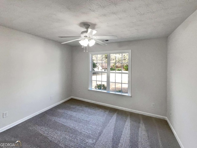 carpeted empty room featuring a textured ceiling and ceiling fan