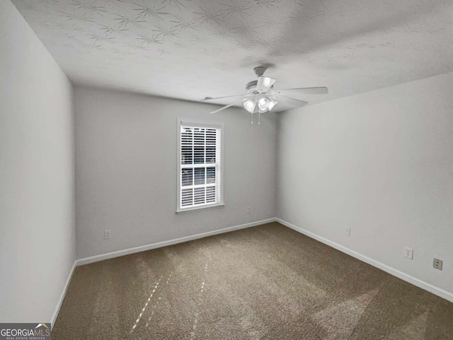 carpeted empty room featuring a textured ceiling and ceiling fan