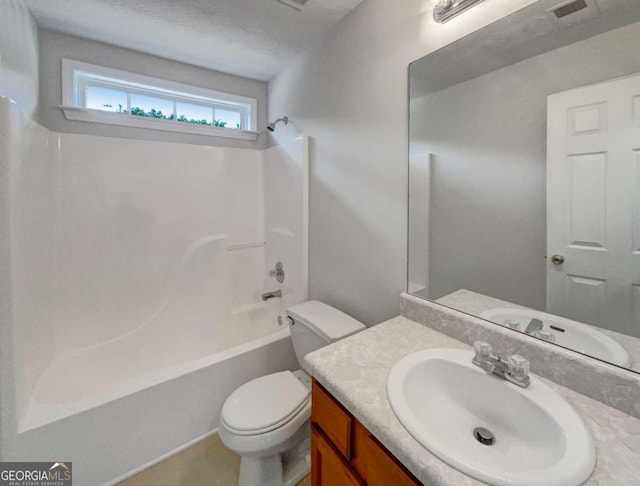 full bathroom featuring toilet, vanity,  shower combination, and a textured ceiling