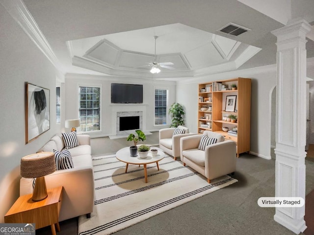 carpeted living room with a premium fireplace, ornamental molding, ceiling fan, decorative columns, and coffered ceiling