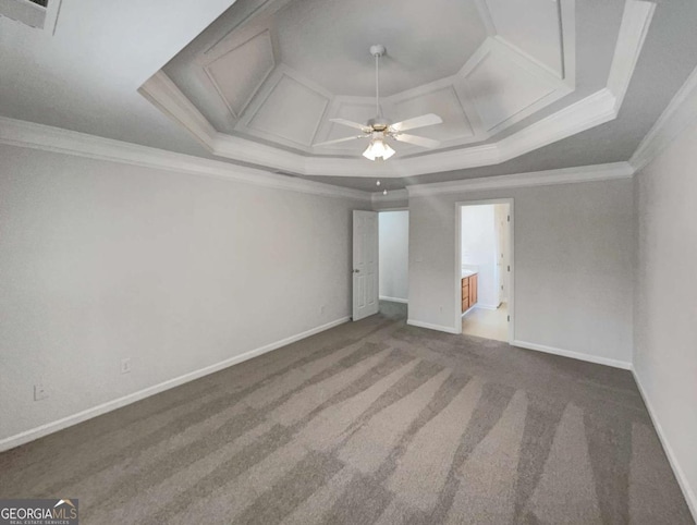 unfurnished room with ceiling fan, carpet, a raised ceiling, and crown molding