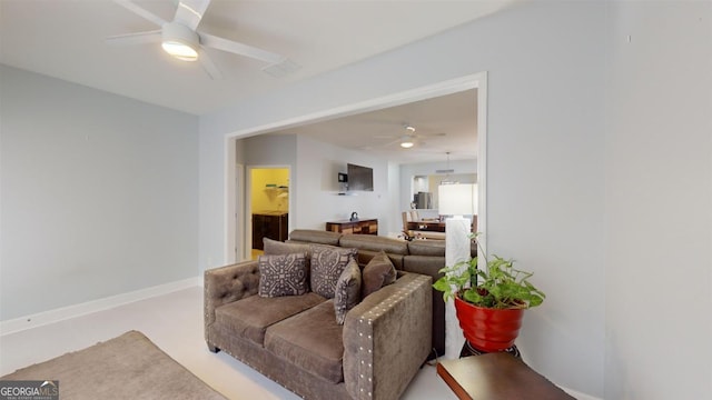 living room featuring ceiling fan and concrete floors