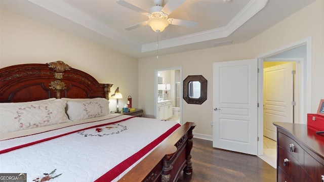 bedroom featuring ensuite bath, dark hardwood / wood-style floors, a raised ceiling, ceiling fan, and crown molding