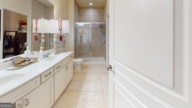 bathroom with tile patterned floors, an enclosed shower, vanity, and toilet