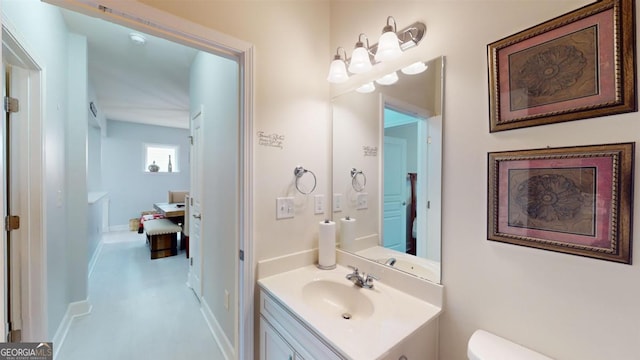 bathroom featuring toilet and vanity