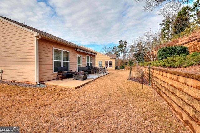 view of yard featuring a fire pit and a patio