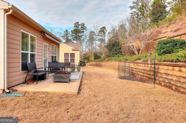 view of yard with a fire pit and a patio