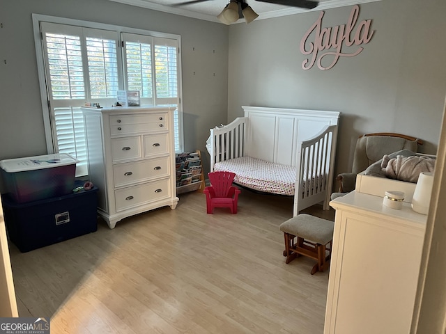 bedroom with ceiling fan, crown molding, and light hardwood / wood-style flooring