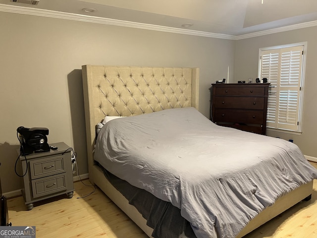 bedroom featuring light wood-type flooring and ornamental molding