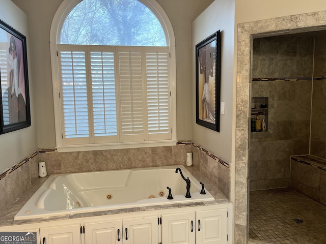 bathroom featuring independent shower and bath