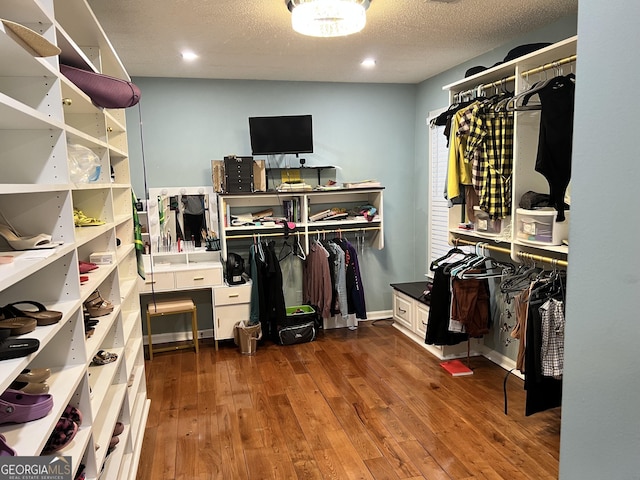 spacious closet featuring dark hardwood / wood-style flooring