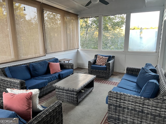 sunroom / solarium with ceiling fan and vaulted ceiling