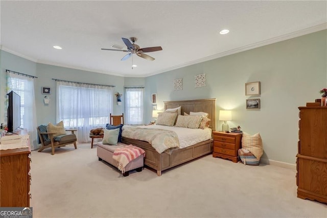 carpeted bedroom featuring ceiling fan and crown molding