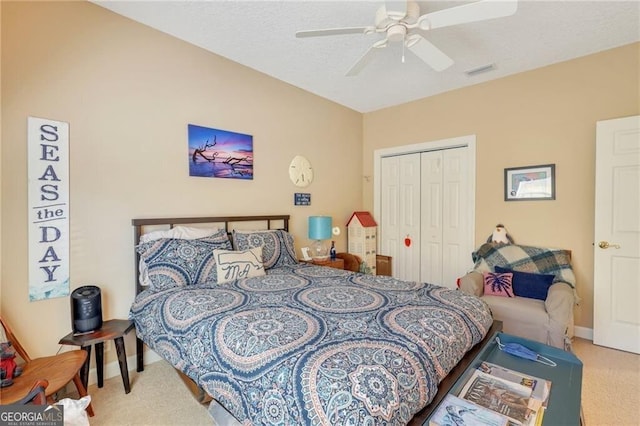 bedroom featuring ceiling fan, a closet, and carpet floors