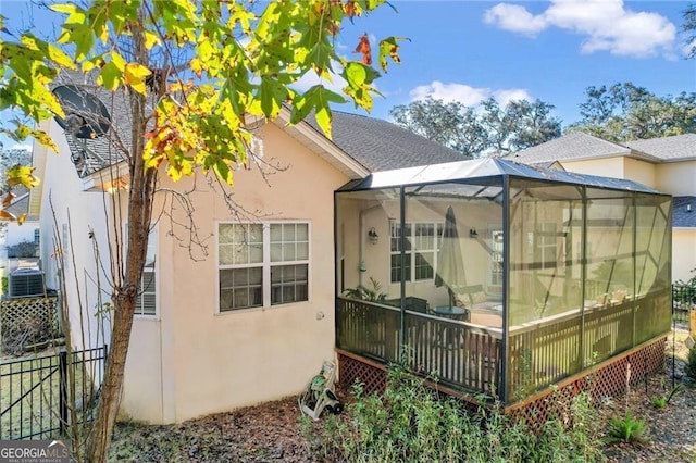 view of home's exterior featuring a lanai and central AC