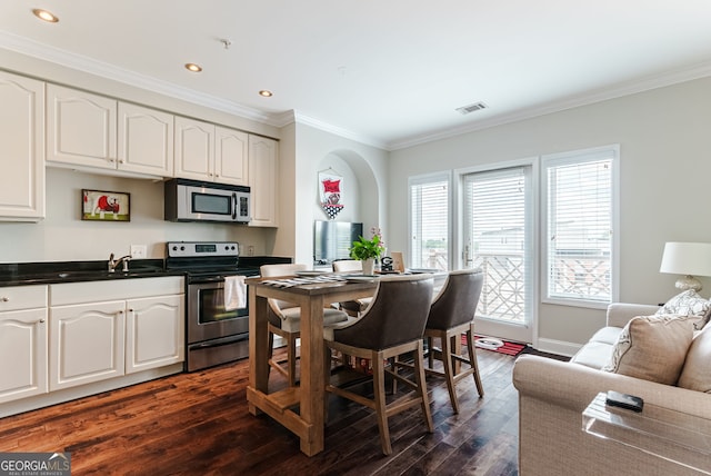 kitchen with white cabinets, dark hardwood / wood-style flooring, sink, and stainless steel appliances