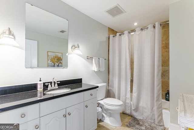 full bathroom with toilet, vanity, shower / bath combo, and tile patterned flooring