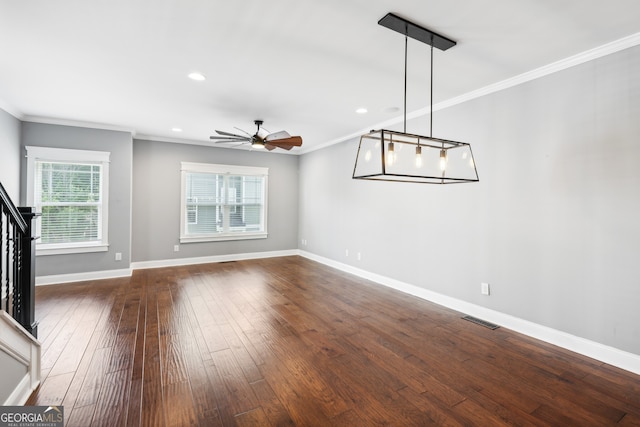 interior space featuring crown molding, ceiling fan, and dark wood-type flooring