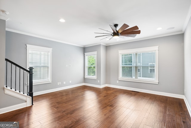 spare room with crown molding, dark hardwood / wood-style floors, and ceiling fan