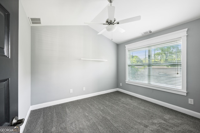 carpeted empty room featuring ceiling fan and vaulted ceiling