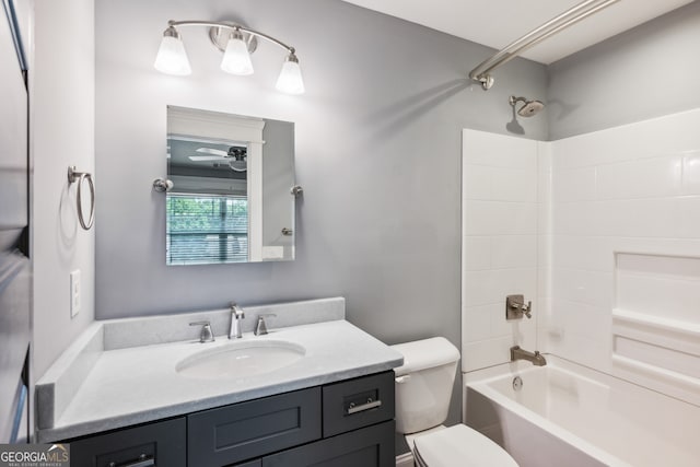 full bathroom featuring vanity, ceiling fan, bathing tub / shower combination, and toilet