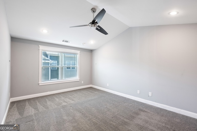 spare room with ceiling fan, lofted ceiling, and carpet flooring