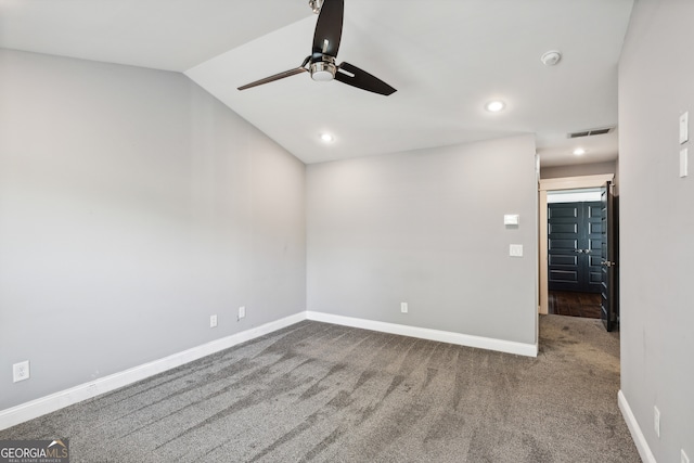 carpeted spare room featuring lofted ceiling and ceiling fan