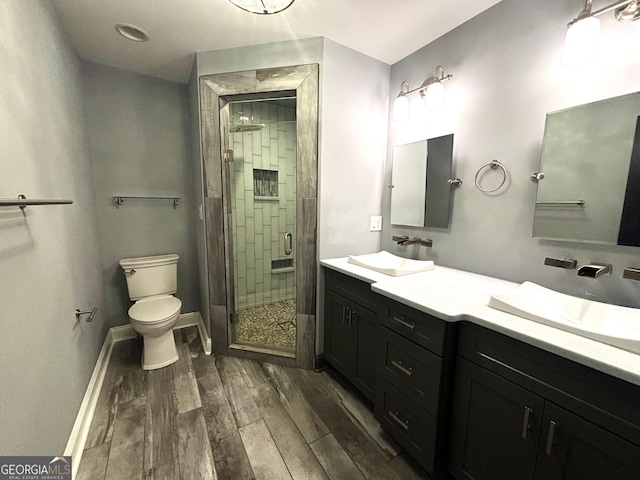 bathroom featuring vanity, an enclosed shower, and toilet