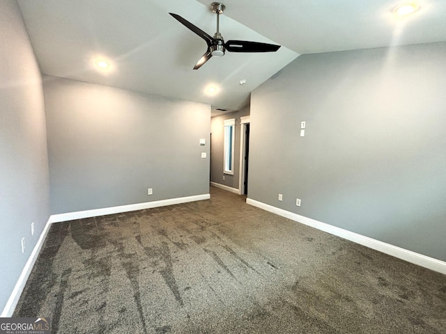 carpeted empty room with ceiling fan and lofted ceiling