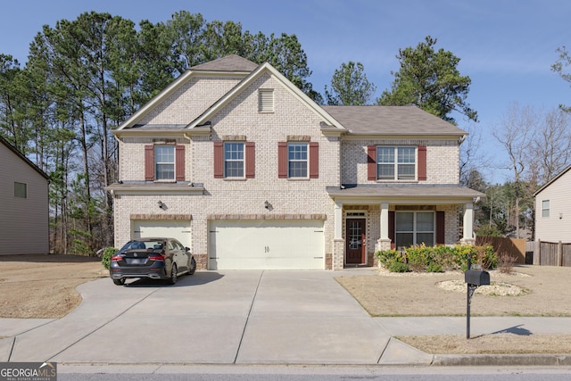 view of front of home featuring covered porch and a garage