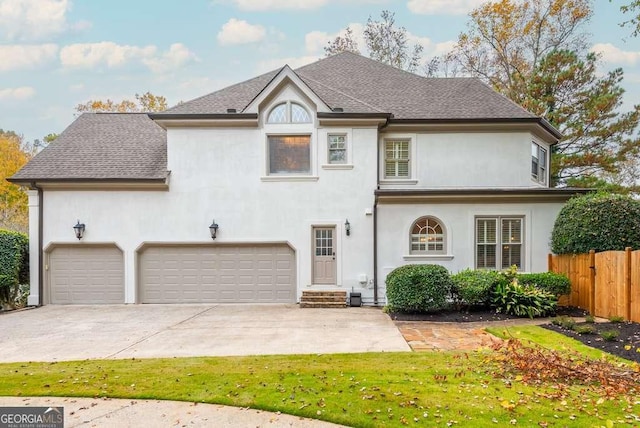 view of front of house featuring a front lawn and a garage