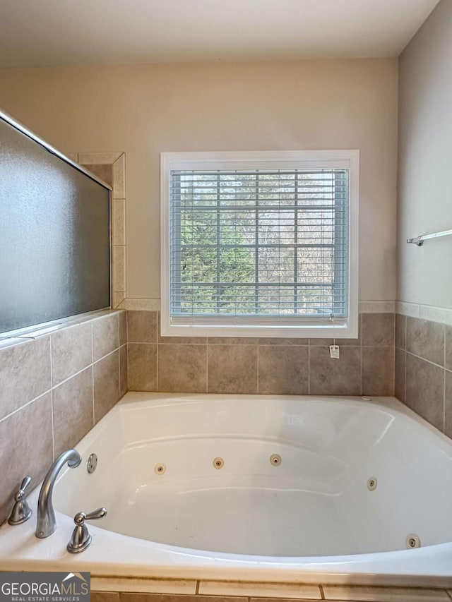 bathroom featuring tiled bath