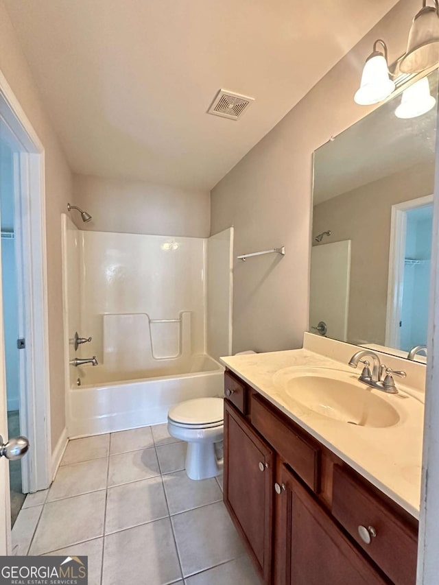 full bathroom with tile patterned floors, shower / bathing tub combination, vanity, and toilet