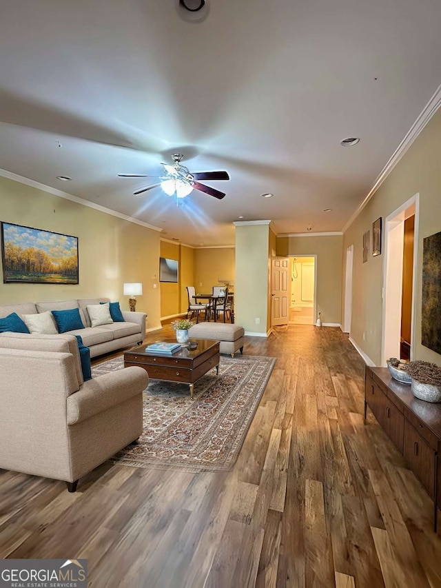 living room with ceiling fan, ornamental molding, and hardwood / wood-style floors