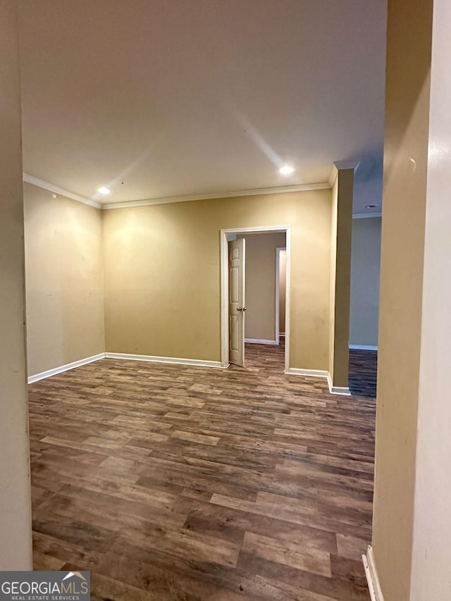 unfurnished room with dark hardwood / wood-style floors and crown molding