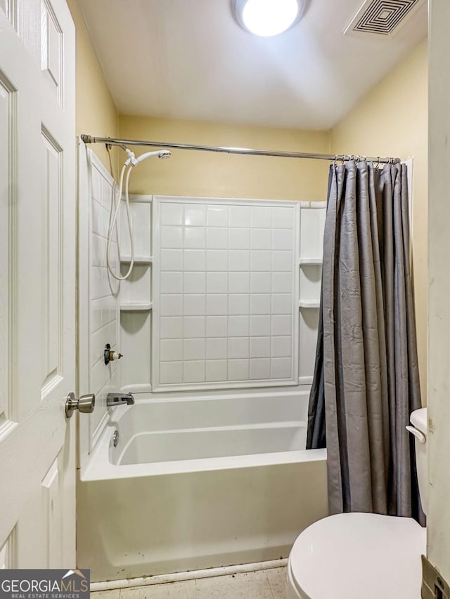 bathroom featuring tile patterned floors, toilet, and shower / bath combination with curtain