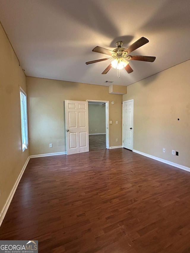 unfurnished room with ceiling fan and dark hardwood / wood-style floors