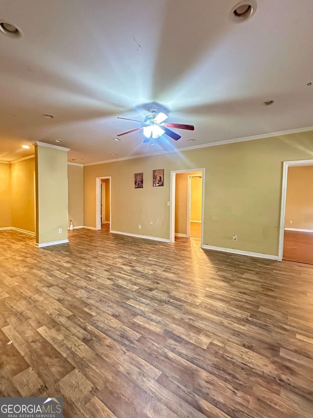 spare room with ceiling fan, crown molding, and wood-type flooring