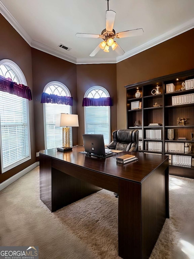 carpeted home office with ceiling fan and crown molding