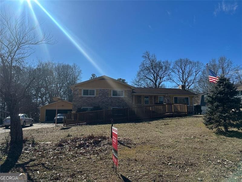 back of property with a garage and an outdoor structure